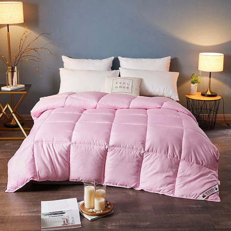 Goose down winter duvet core in twill fabric, shown in various colour options on a bed.