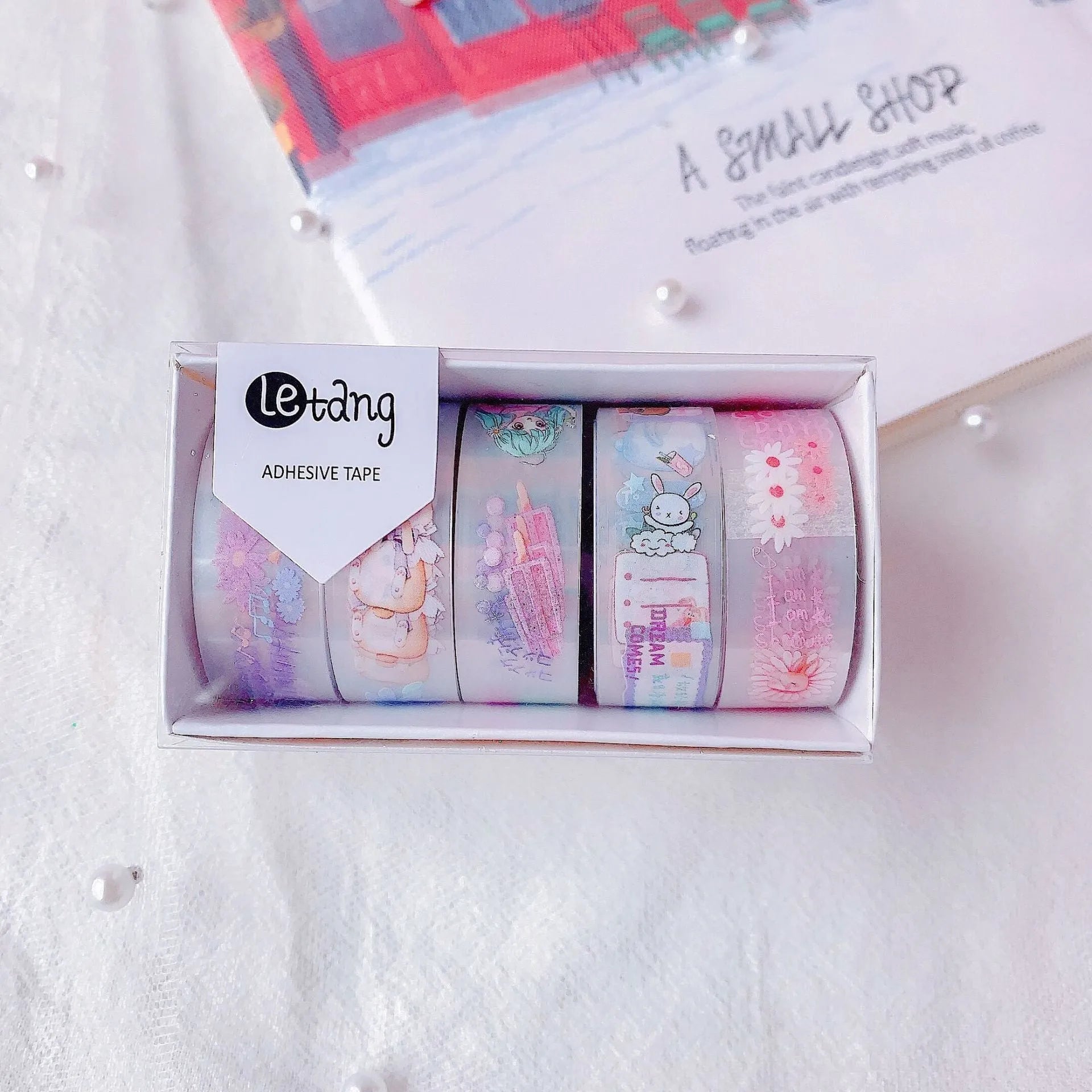 Pack of Japanese washi paper tape stickers in 1.5cm width with cartoon designs of dinosaurs, ducks, girls with rabbits, and lucky cats.