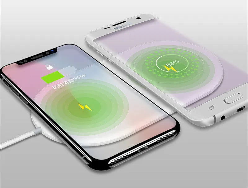 White dual wireless charging pad for two mobile phones on a table