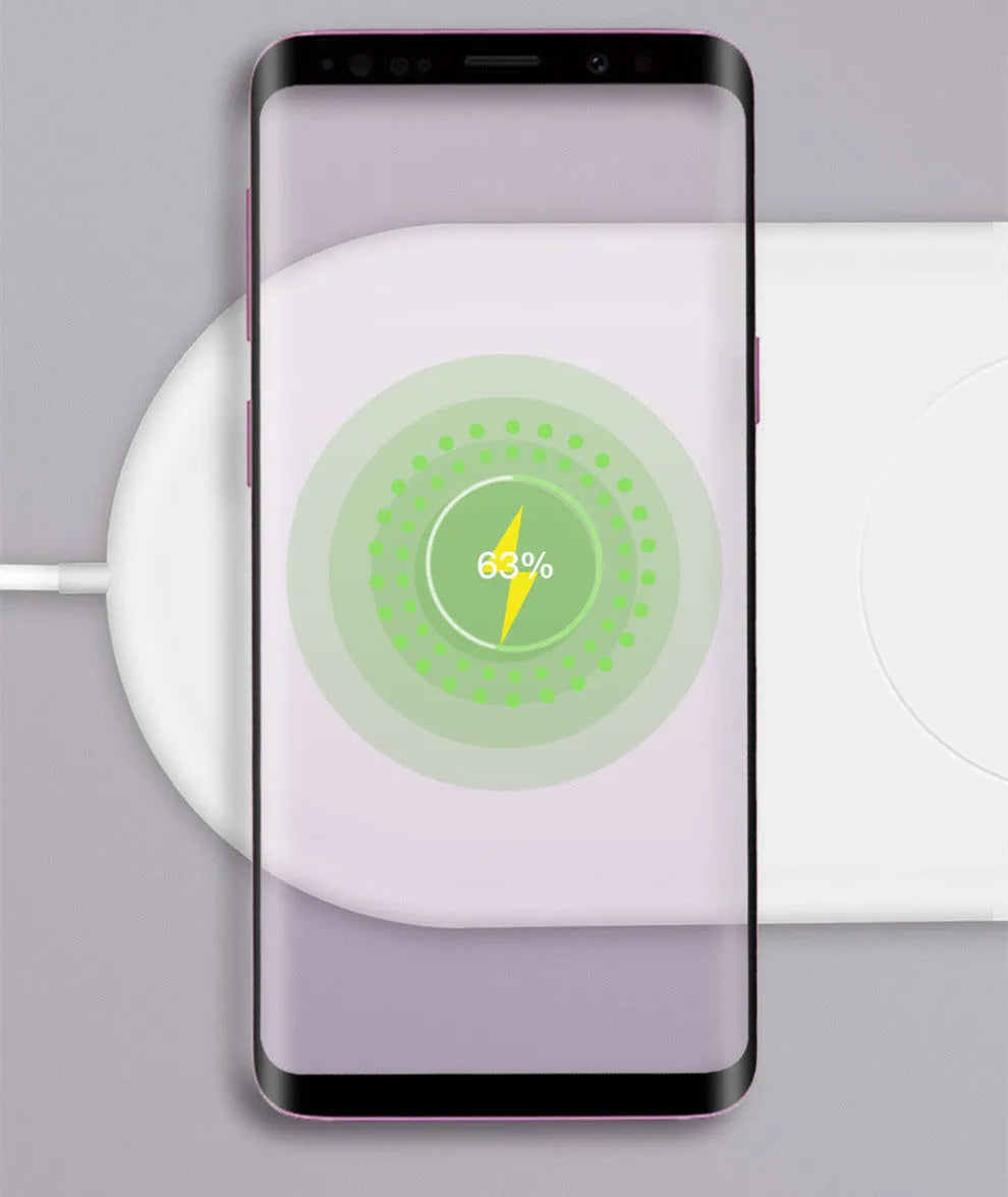 White dual wireless charging pad for two mobile phones on a table