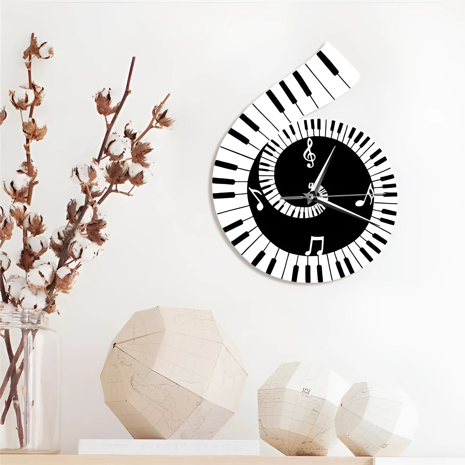 Black and white irregular shape wall clock decorated with treble clef symbol and piano keyboard graphic