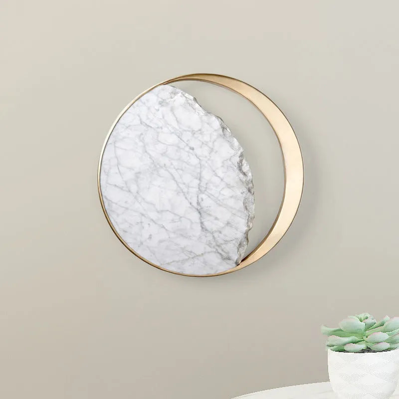 Circular marble and copper eclipse art design LED wall lamp mounted on a wall.