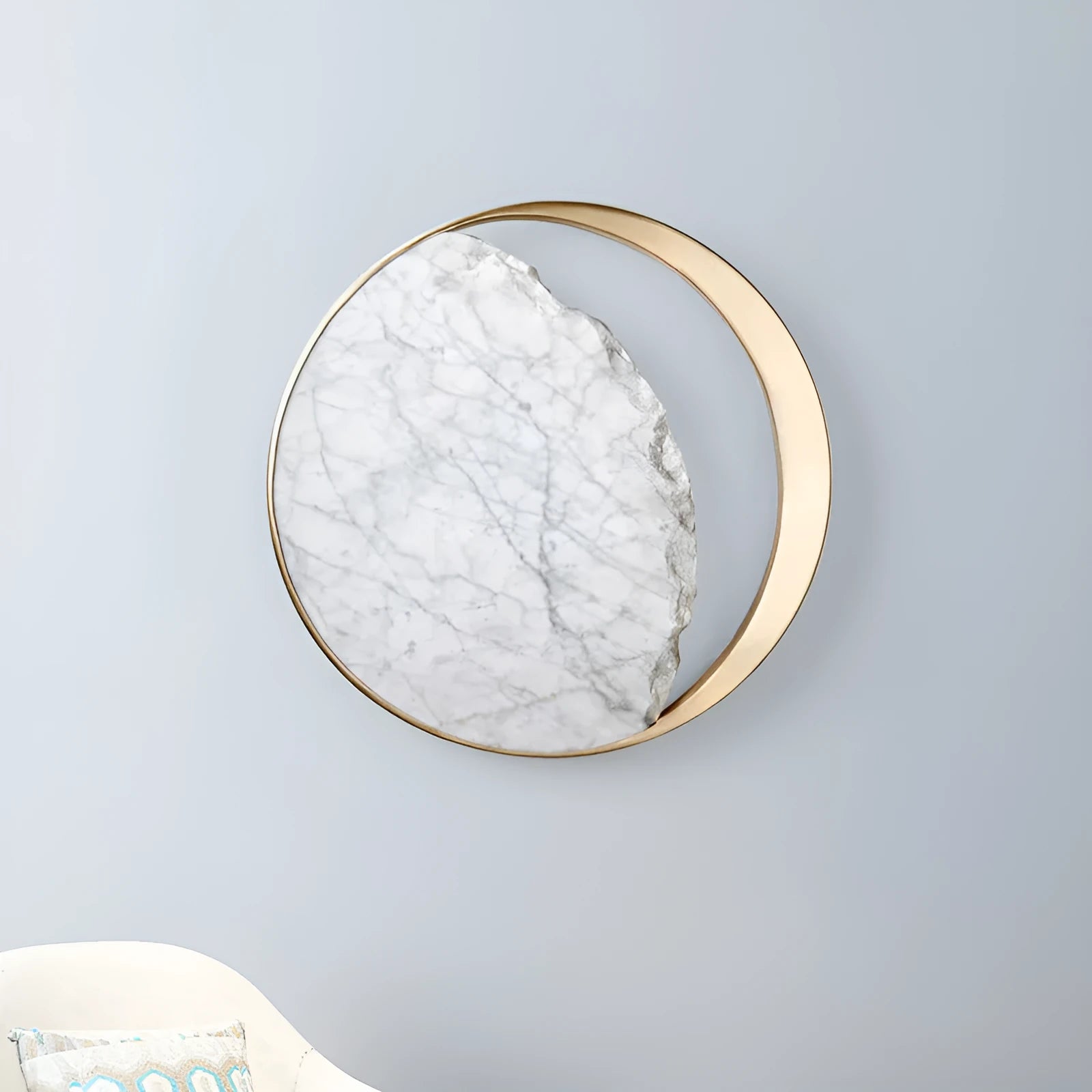 Circular marble and copper eclipse art design LED wall lamp mounted on a wall.
