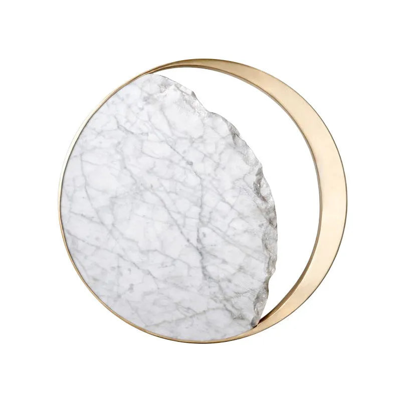Circular marble and copper eclipse art design LED wall lamp mounted on a wall.