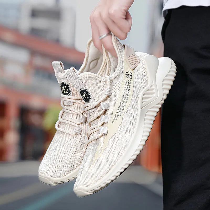 Men's white mesh sports shoes with rubber sole and lace-up front, shown on a plain background.