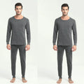 Men's round neck polyester thermal underwear suit in black with slim fit top and bottom on white background