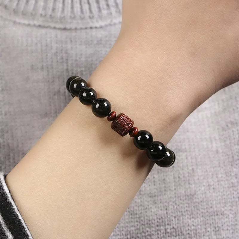 Golden obsidian vintage bracelet with hand-woven construction and national style design elements