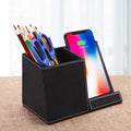 Black leather wireless charging station with pen holder compartment and phone charging surface