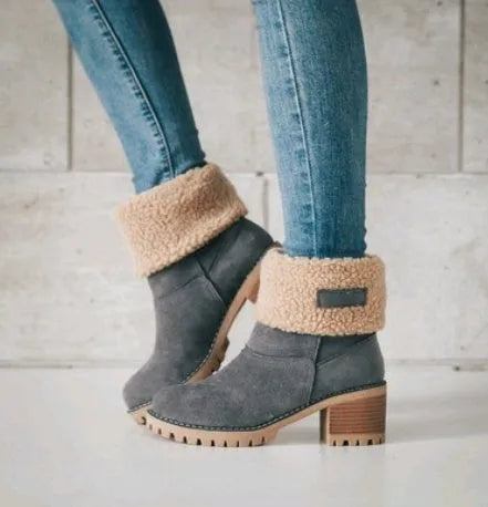 Women's black suede mid-tube snow boots with a thick flat heel and round toe on a white background.