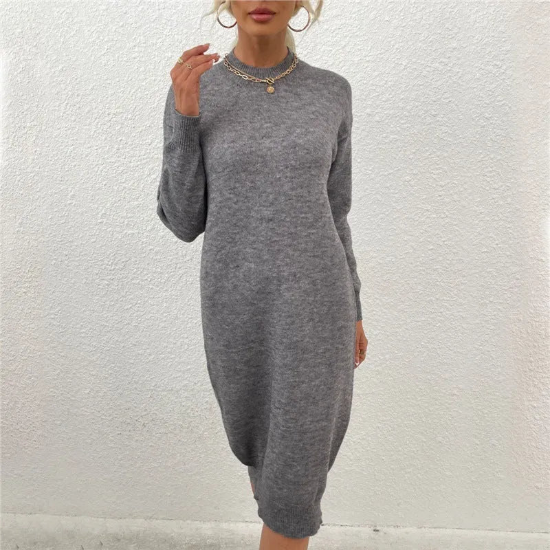 Grey women's crew neck long sleeve acrylic sweater dress on a hanger.