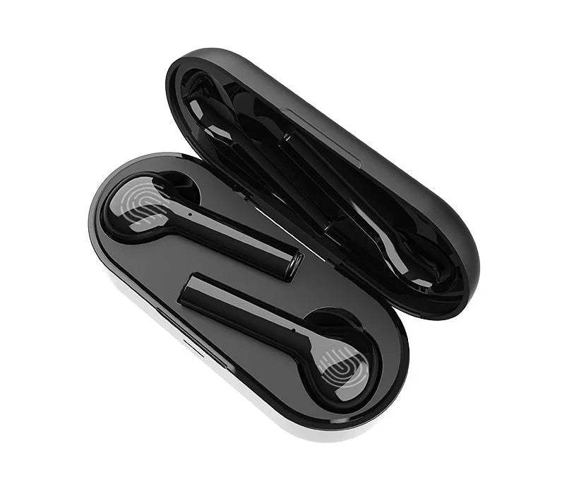Black and white wireless in-ear Bluetooth headphones with a charging case on a table.