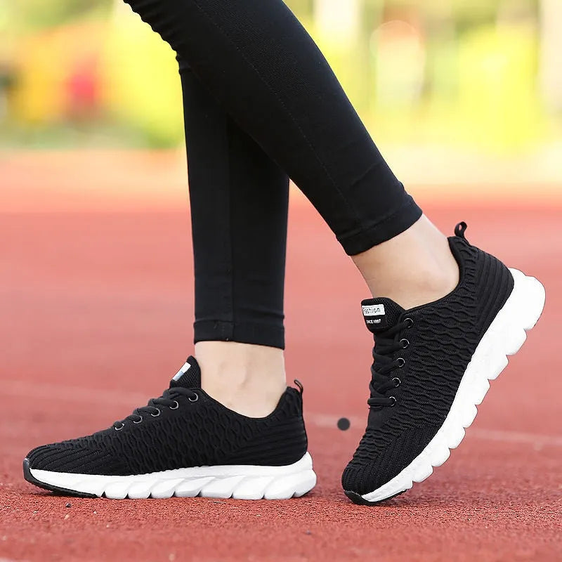Women's running shoes showing fly weaving upper material and wear-resistant outsole in black, pink, or white colour options