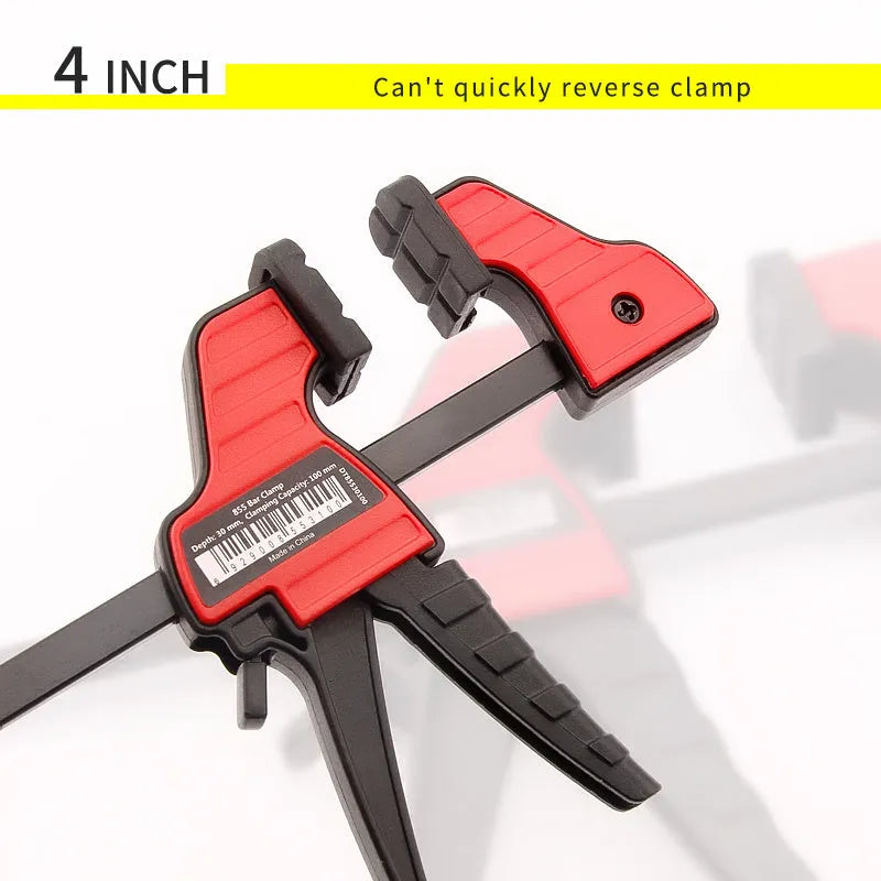 Black plastic one-handed ratcheting woodworking clamp with a quick-release trigger and soft rubber protective grips.
