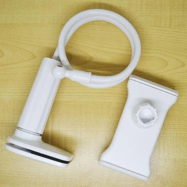 Black bedside phone handset with a long aluminium arm holding a mobile phone on a table.