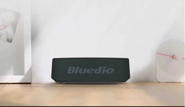 Black BS-6 cloud smart speaker showing front grill and control buttons.