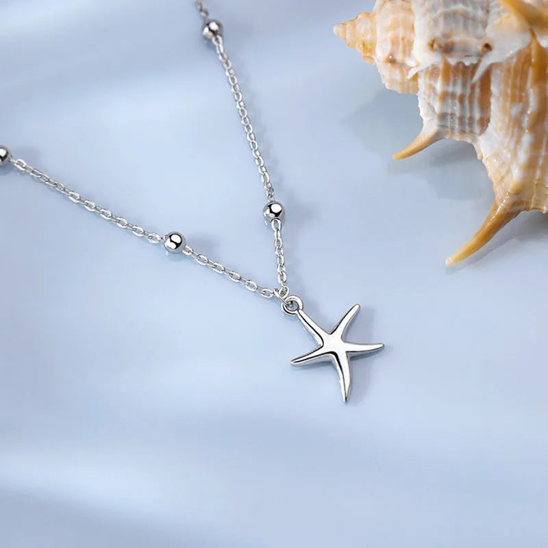 Sterling silver anklet with a starfish charm on a round bead chain.