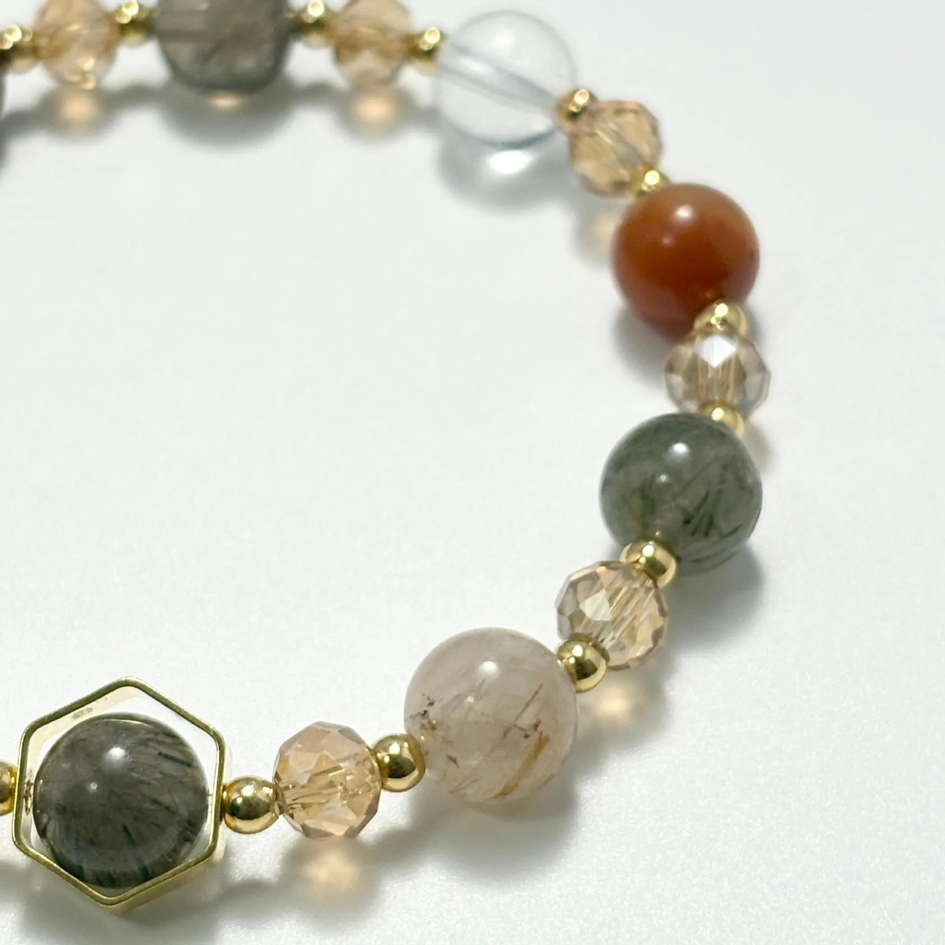 Gold citrine crystal bracelet with hand-woven construction showing auspicious Chinese symbols