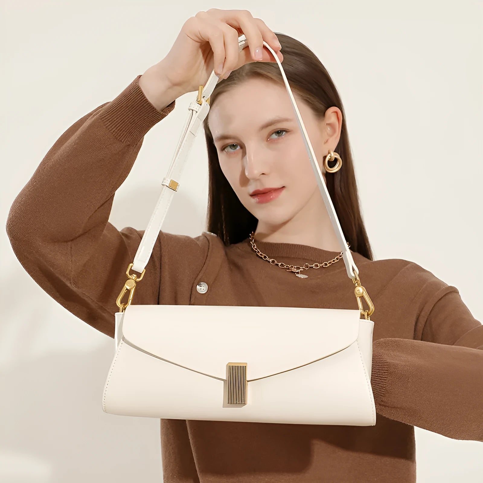 Women's cowhide leather cross-body bag in pillow shape with clamshell opening