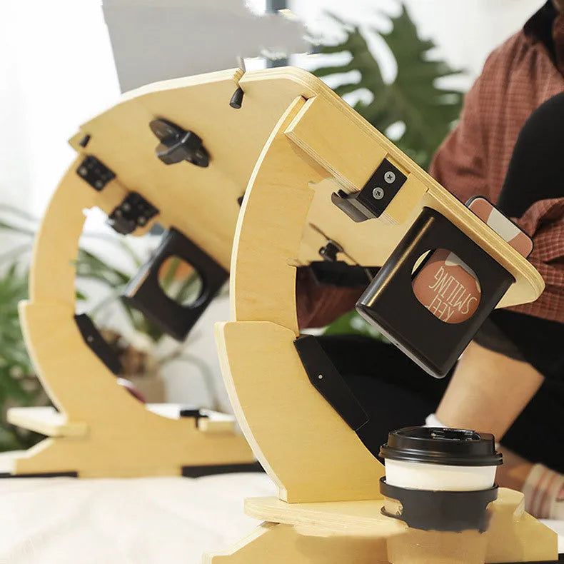 White wooden folding bed table with adjustable angle, holding a laptop.