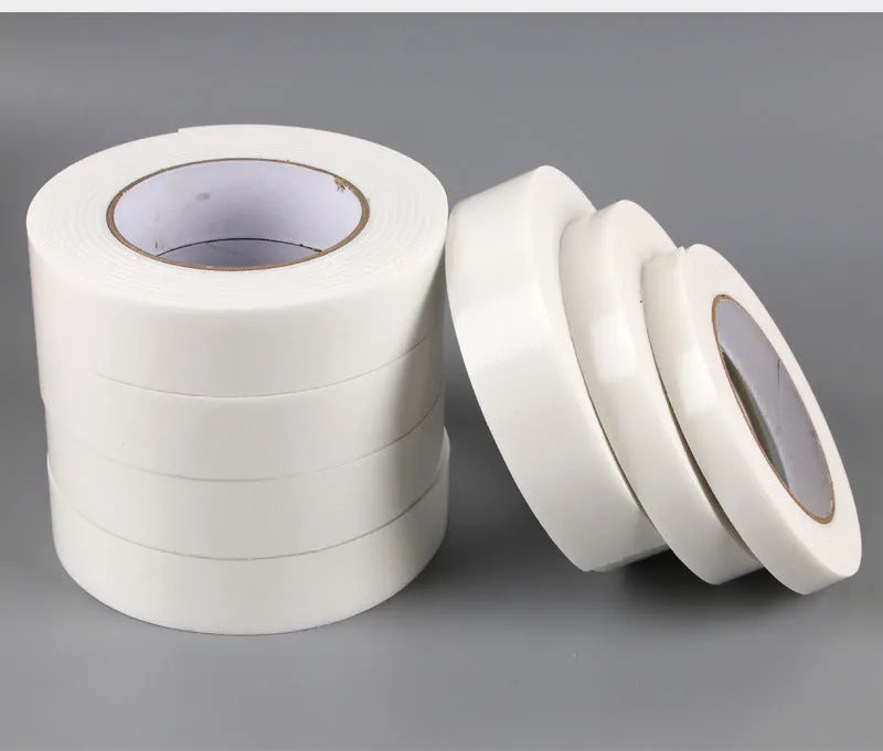 Roll of white foam double-sided adhesive tape showing its thickness, with size options 15mm, 18mm, and 30mm wide.