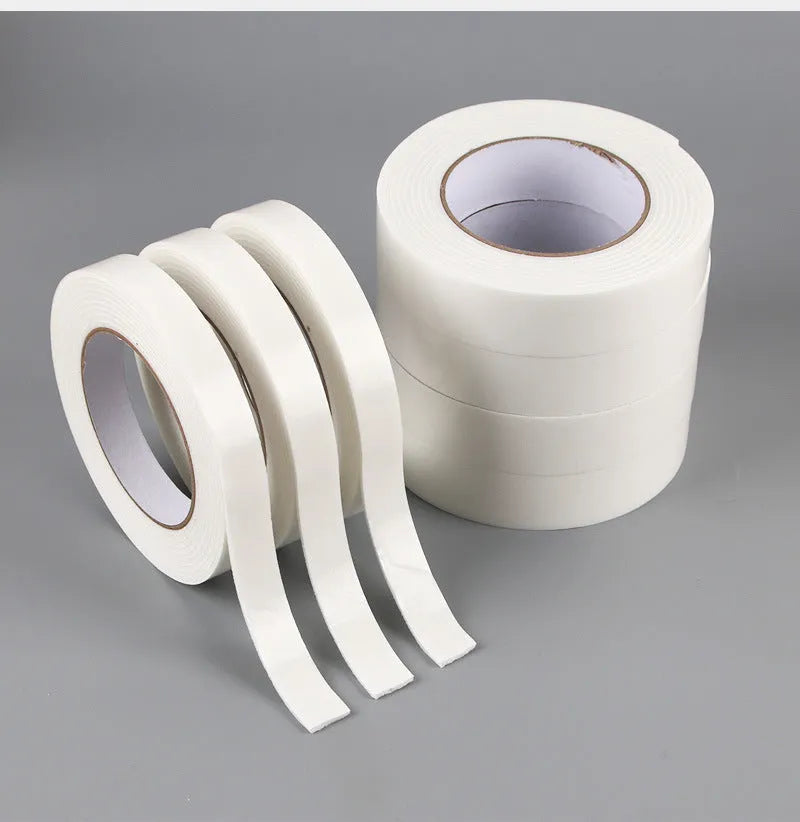 Roll of white foam double-sided adhesive tape showing its thickness, with size options 15mm, 18mm, and 30mm wide.