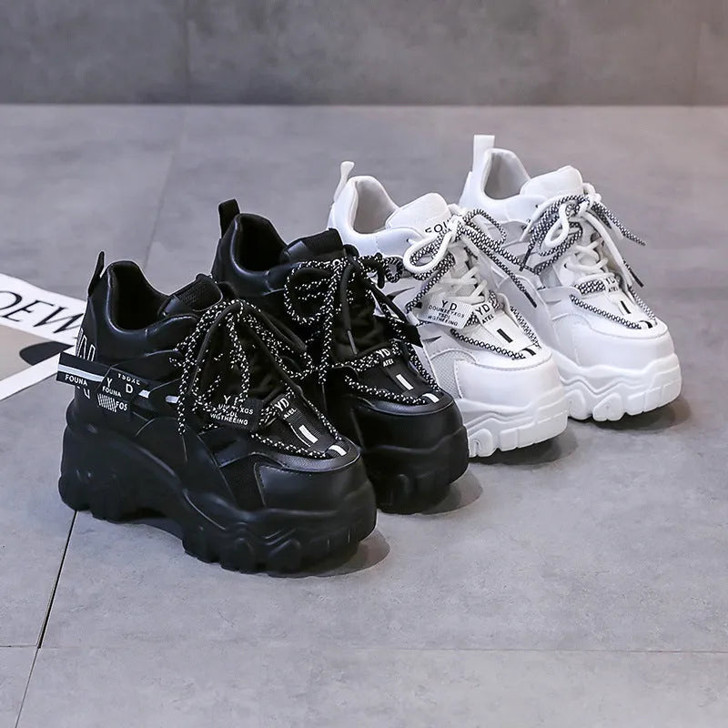 Women's white mesh platform sports shoes with a cross strap and rubber sole.
