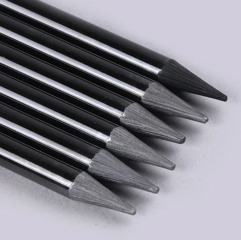 Set of six graphite and three carbonised drawing pencils on suction card packaging