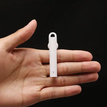 Compact black and white wireless Bluetooth earpiece showing 5.6 cm size dimensions