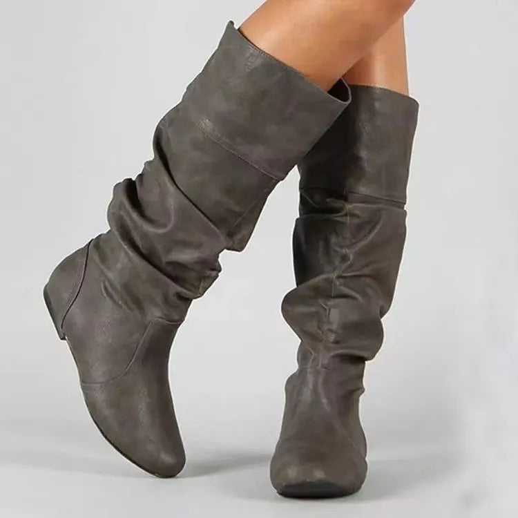 Women's flat slip-on ankle boots in black PU leather with a round toe and high-cut design.