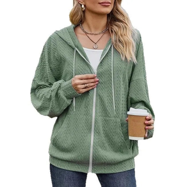 Green women's hooded zipper sweater coat on a hanger, showing loose casual fit.