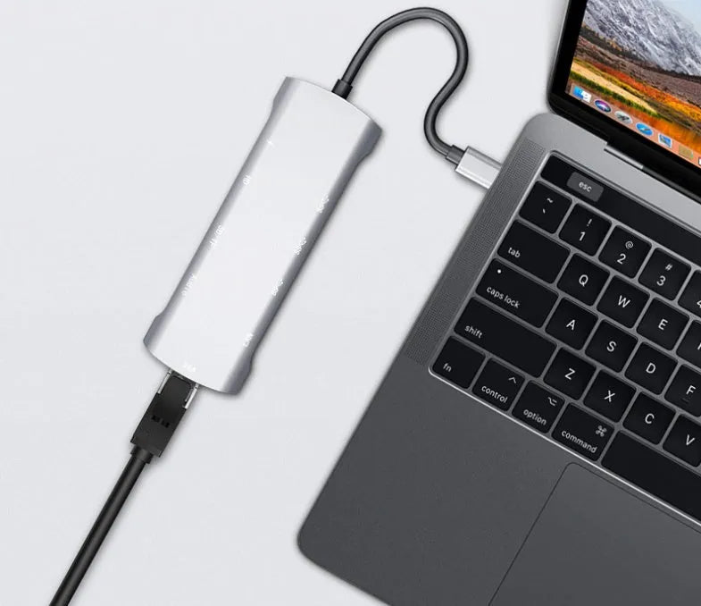 Grey aluminium USB-C docking station showing HDMI, VGA, USB 3.0, and PD charging ports