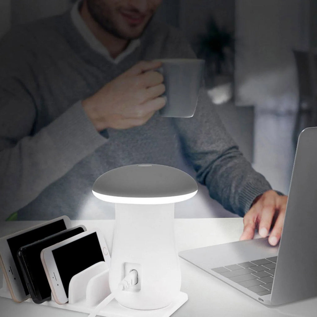 White mushroom-shaped LED light on a five-port USB charging station for phones and tablets