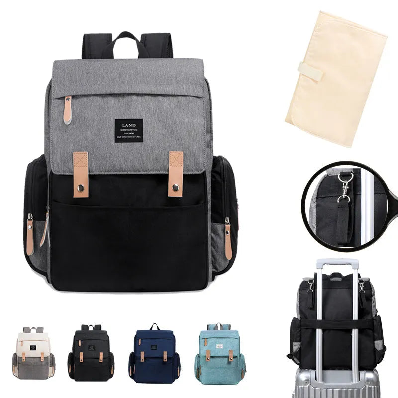 LAND Mommy Diaper Backpack in Oxford cloth with integrated changing mat, showing backpack straps and main compartment.