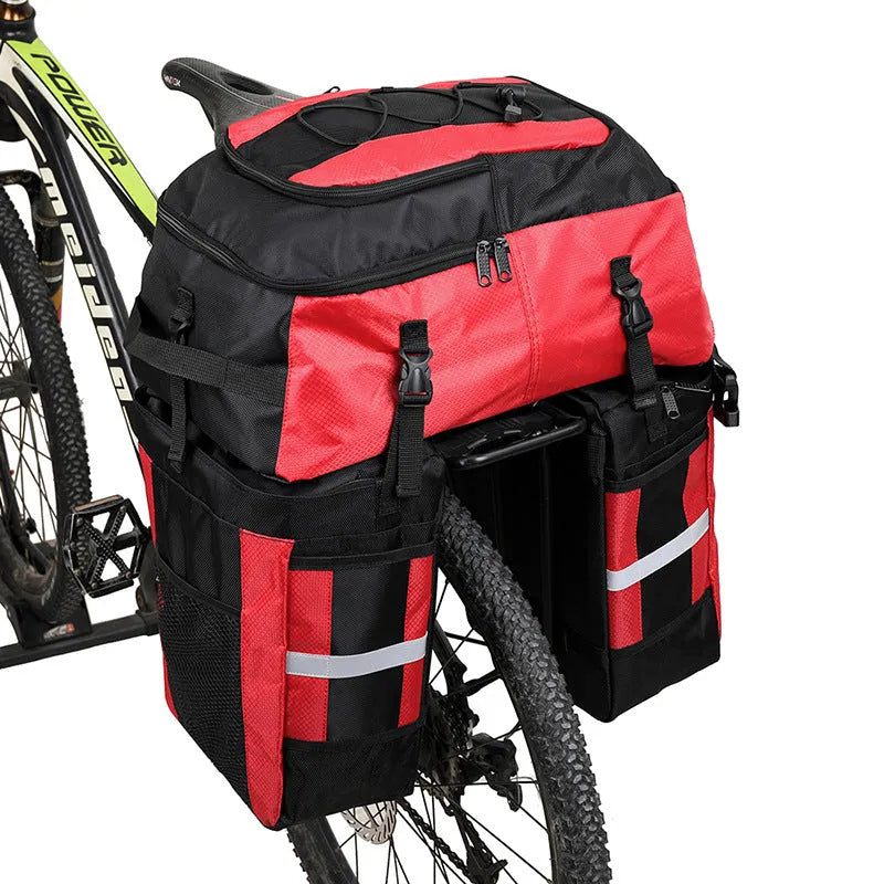 Green bicycle rear storage bag with 70 litre capacity mounted on a bike rack for touring.