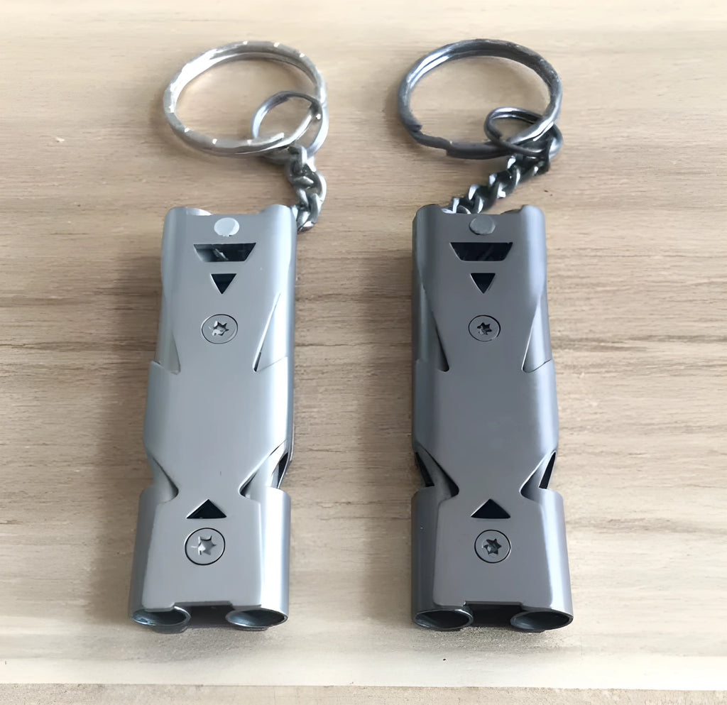 Compact keychain whistle in black and silver with keychain attachment for portable emergency signalling