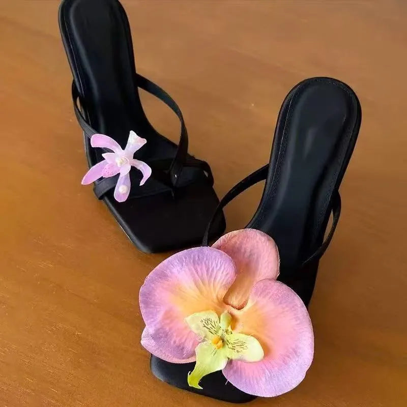 Handmade women's high-heel sandals with an asymmetric flower design on a calf leather upper.