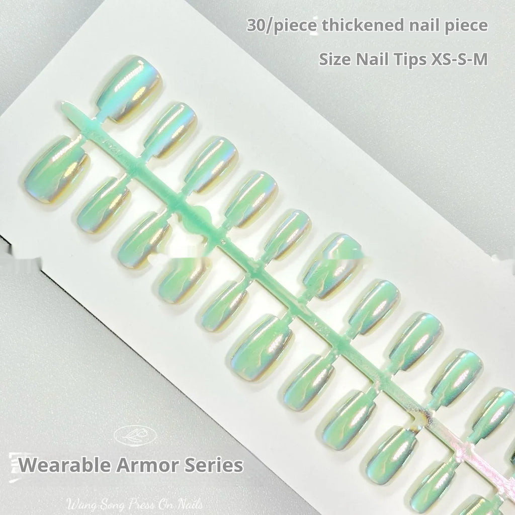 Set of electroplated Cat's Eye false nails in short ladder almond shape on a blue background, showing Aurora armour and solid colour designs.