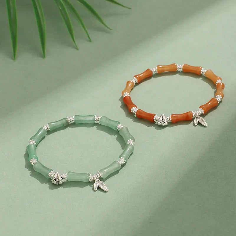 Green aventurine bamboo strawberry quartz crystal bracelet with mixed natural stones on wrist