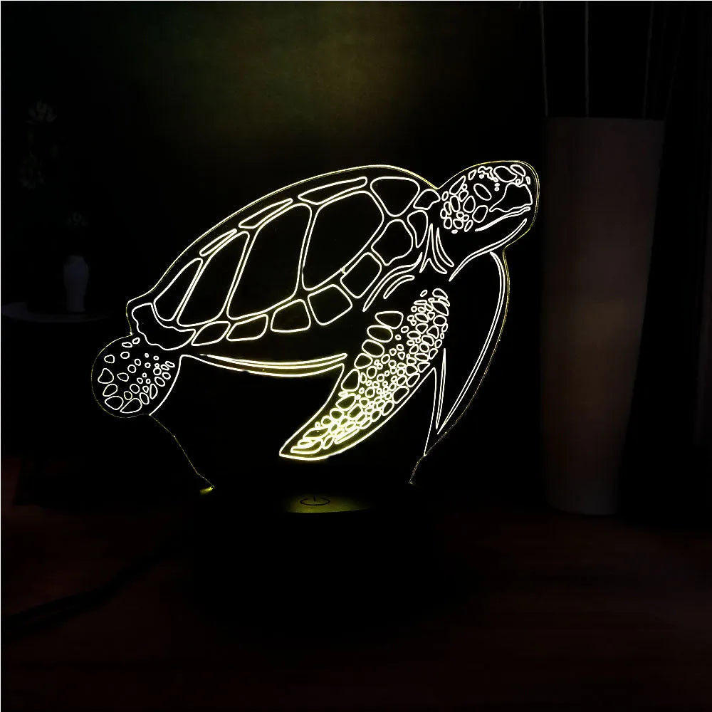 3D green turtle-shaped LED night light with colourful glow, showing remote control and USB cable.