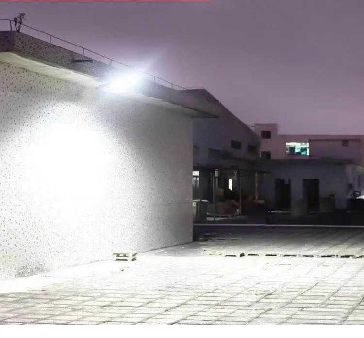 Black solar-powered outdoor motion sensor light mounted on a wall or fence post.