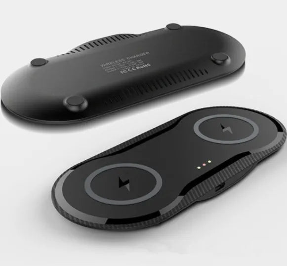 Black and white dual wireless charger showing two phones charging simultaneously on separate pads
