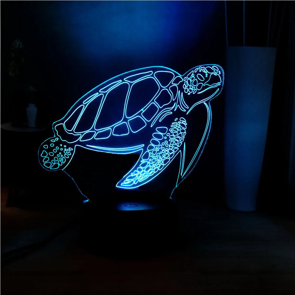 3D green turtle-shaped LED night light with colourful glow, showing remote control and USB cable.