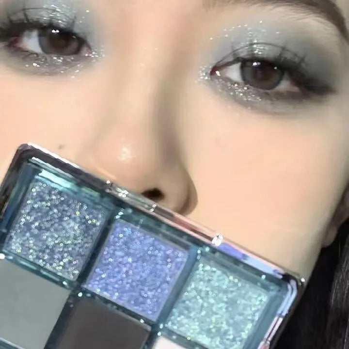 MUGELEEN nine-colour eye shadow palette open showing low saturation blue and complementary shades