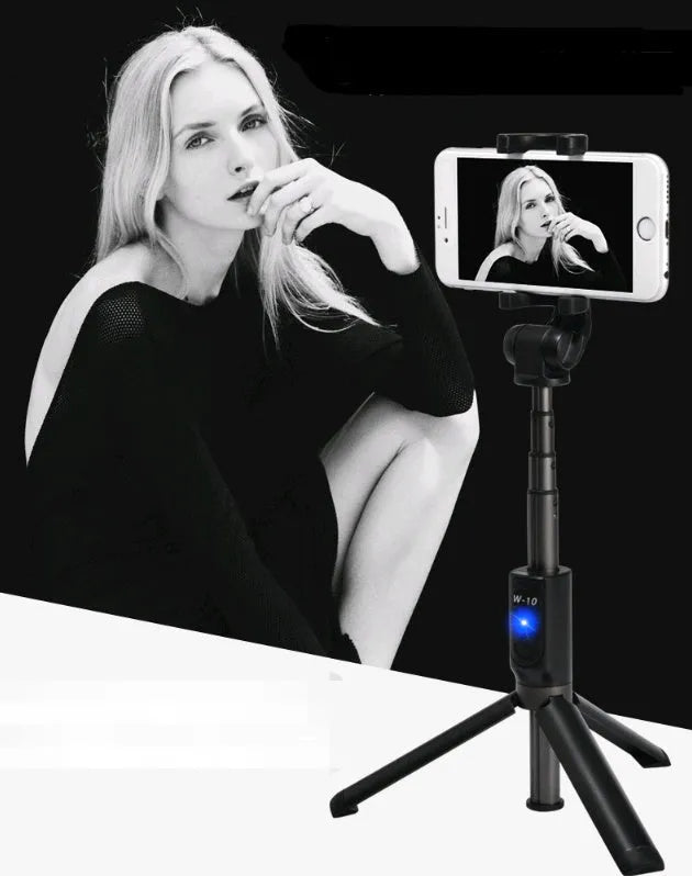 Aluminium alloy Bluetooth selfie stick with remote control and adjustable phone clip next to a smartphone