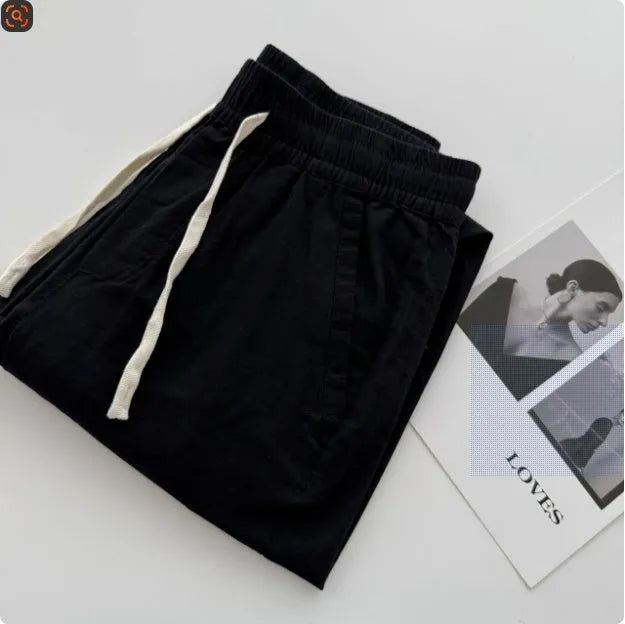 Men's loose-fitting straight-leg casual pants in beige colour with an elasticated drawstring waistband.