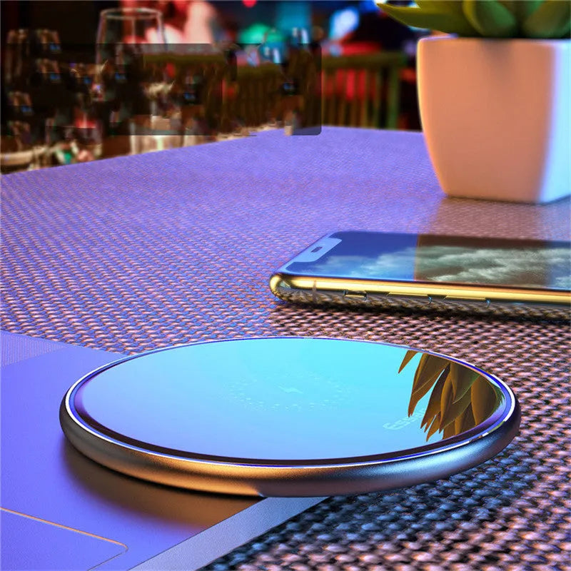 Black aluminium wireless charging pad with LED light and phone positioned for Qi charging