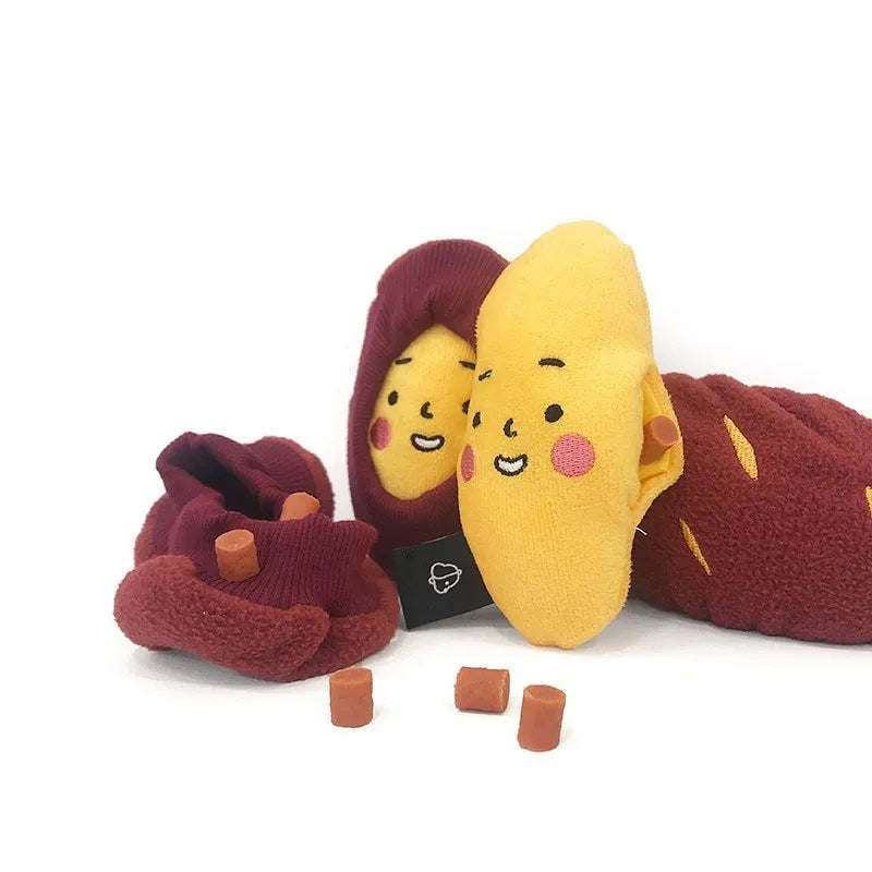 Red sweet potato dog puzzle toy with removable peel showing internal treat pockets