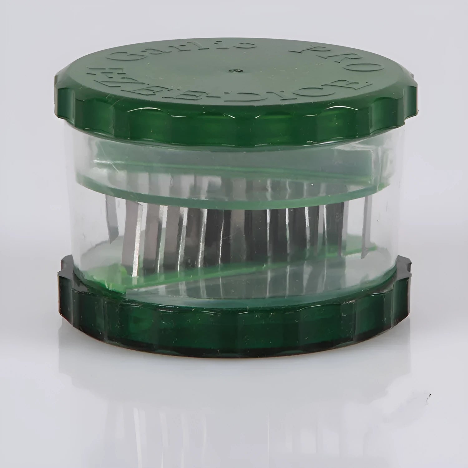 Green transparent polypropylene garlic peeler on a kitchen counter