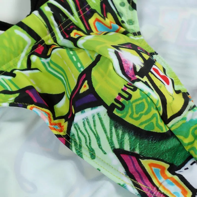 Men's printed polyester swim trunks in skull graphic design on a mannequin