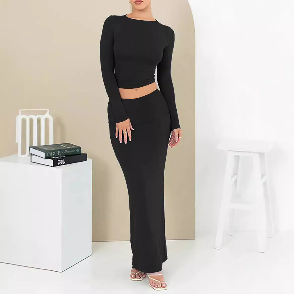 Women's slim fit polyester two-piece suit set with top, long skirt, and exposed navel detail.